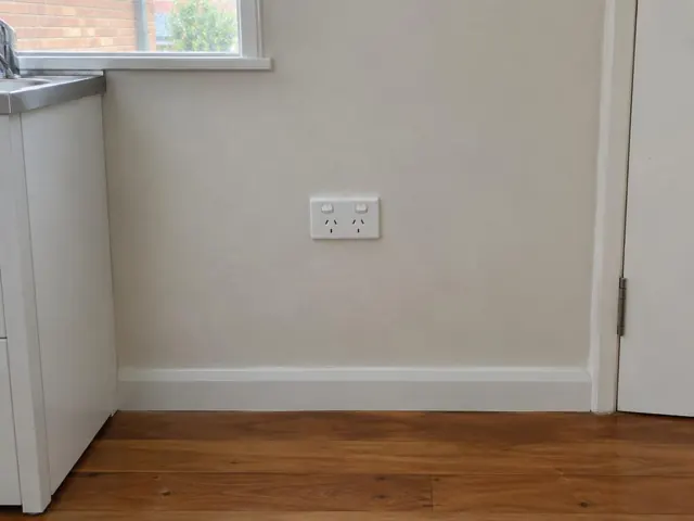 White double power point on a beige kitchen wall above timber floor in a home in Tarro